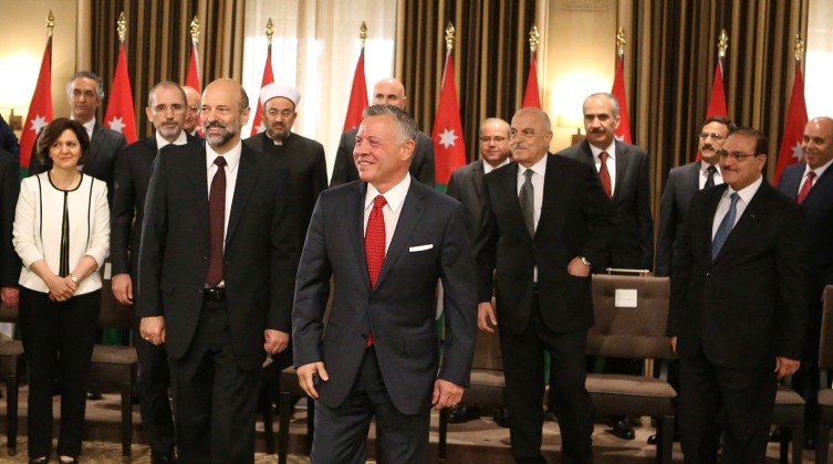 Jordan's King Abdullah II stands near Prime Minister Omar al-Razzaz during a swearing-in ceremony of the new cabinet in Amman