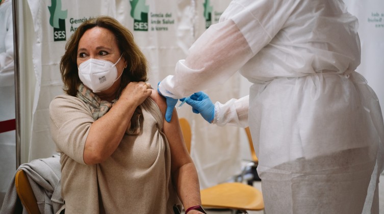 A woman receives a dose of the AstraZeneca vaccine during