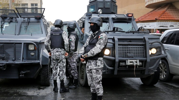 Jordanian policemen stand guard after ending security operations in the vicinity of Karak Castle