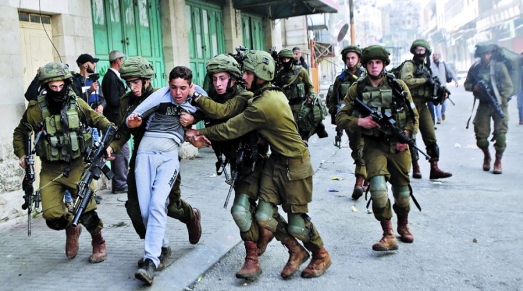Israeli soldiers detain a Palestinian during clashes at a protest in Hebron, in the occupied West Bank