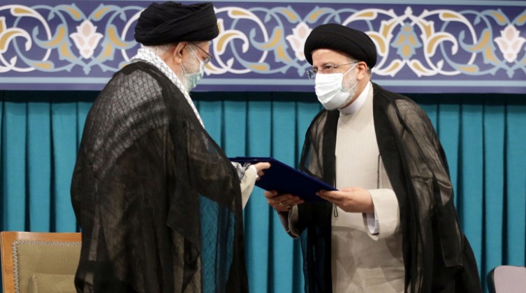 Iran's new President Ebrahim Raisi receives the endorsement decree for his presidency from Iran's Supreme Leader Ayatollah Ali Khamenei, in Tehran
