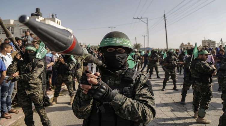 A masked Palestinian activist and a launcher bearer seen