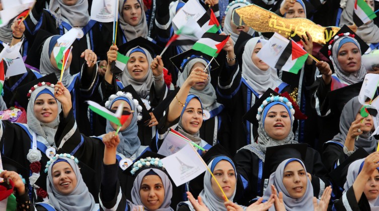 Palestinian students celebrate during their graduation ceremony at al-Aqsa University in Khan Younis in the southern of Gaza strip