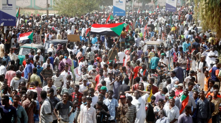 Civilians gather as members of Sudanese pro-democracy protest on the anniversary of a major anti-military protest, as groups loyal to toppled leader Omar al-Bashir plan rival demonstrations in Khartoum